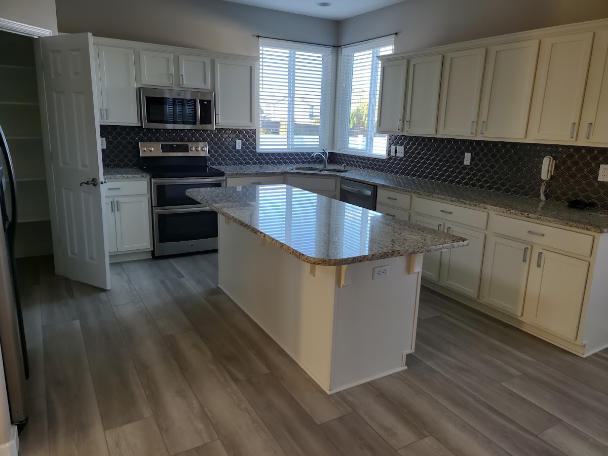 Bright clean kitchen with freshly serviced wood look floor